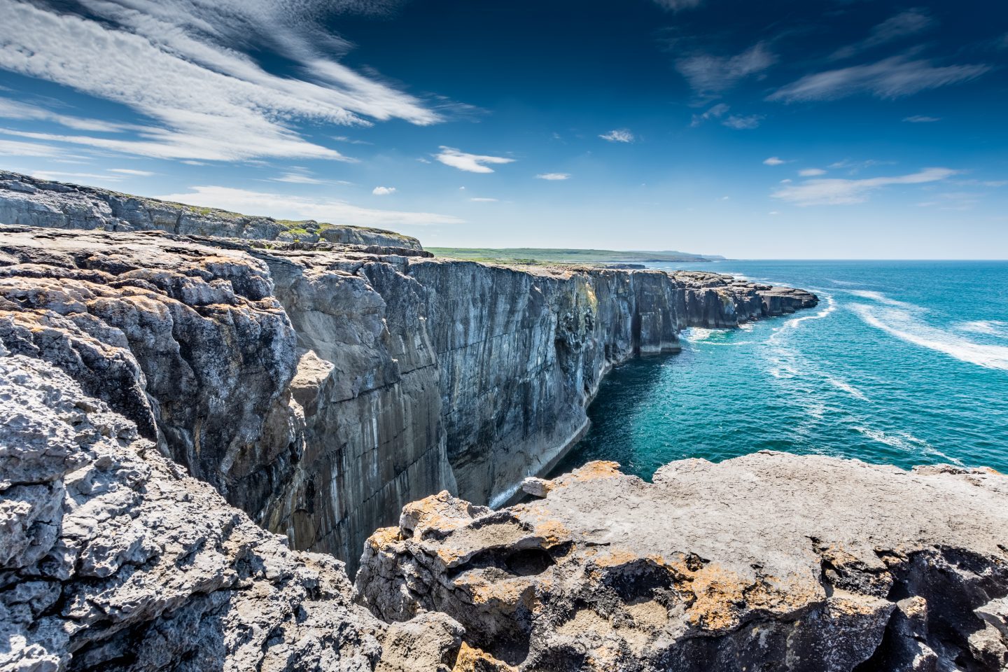 Limestone cliffs abut the sea